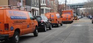 Water Damage Restoration Vans And Trucks At Urban Job Location