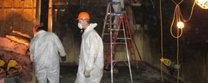 911 Restoration Mold Damage Technician Working In Basement