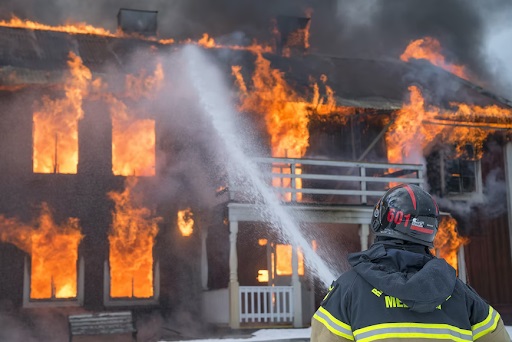 A fireman spraying water with a hose